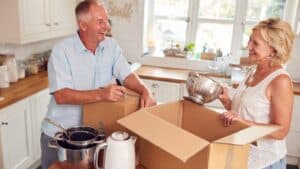 couple packing kitchen appliances in boxs